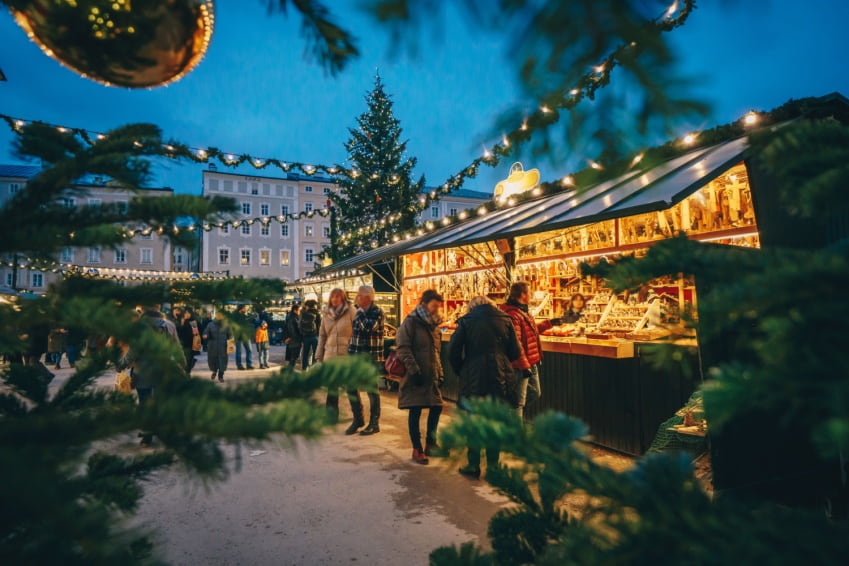 Salzburg Market at Christmas seen through Christmas tree branches