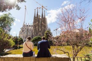 A coupe sitting in front of the Sagrada Familia in Barcelona.