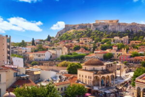 Beautiful view of Athens skyline with Monastiraki Square and the Acropolis, one of the most famous historical sites in Athens, glowing in the summer sun.