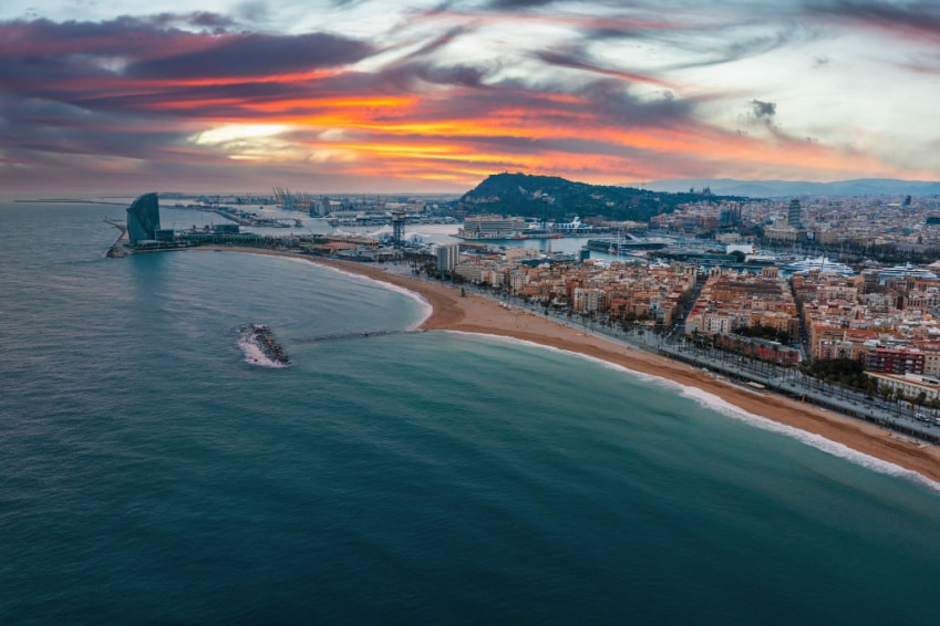 Aerial panorama of the iconic Barceloneta Beach in Barcelona, one of the best beaches in the city and in our Barcelona travel guide.