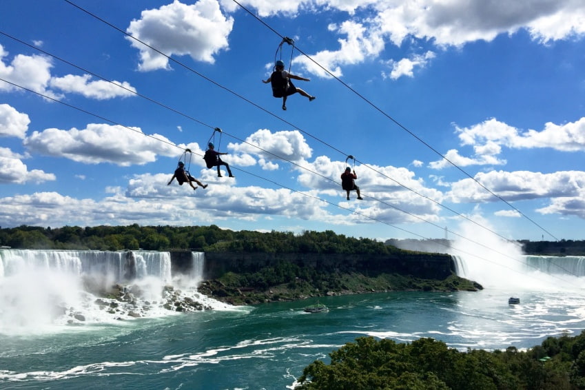 A group of tourists enjoy the zip line ride in Niagara Falls, Ontario, Canada.