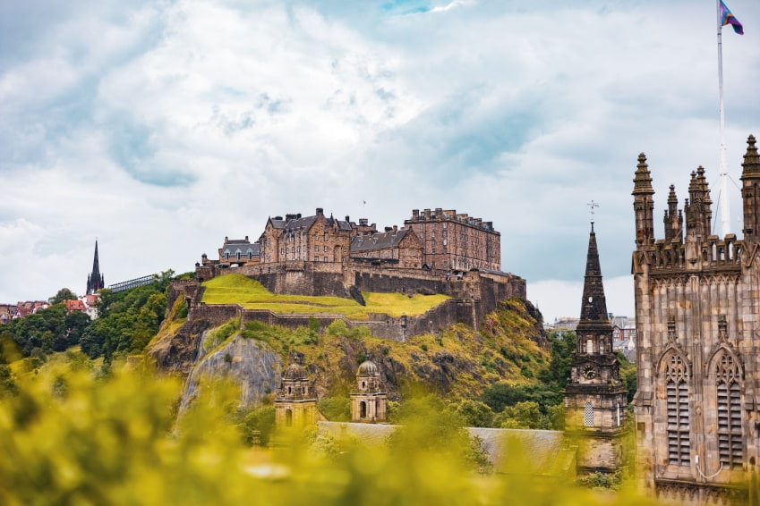 Edinburgh Castle and Scott Monument surrounded by greenery, showing fascinating facts about Edinburgh architecture