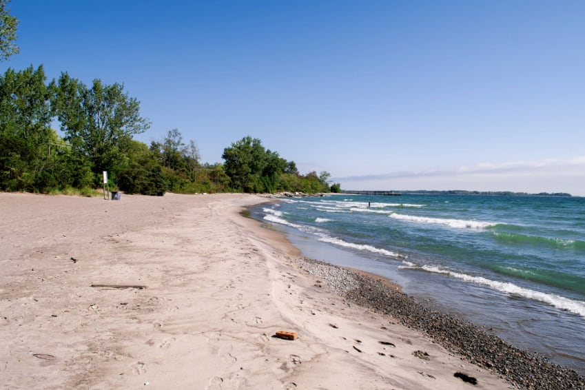 Quiet shoreline at Gibraltar Point with soft sand and clear lake views.